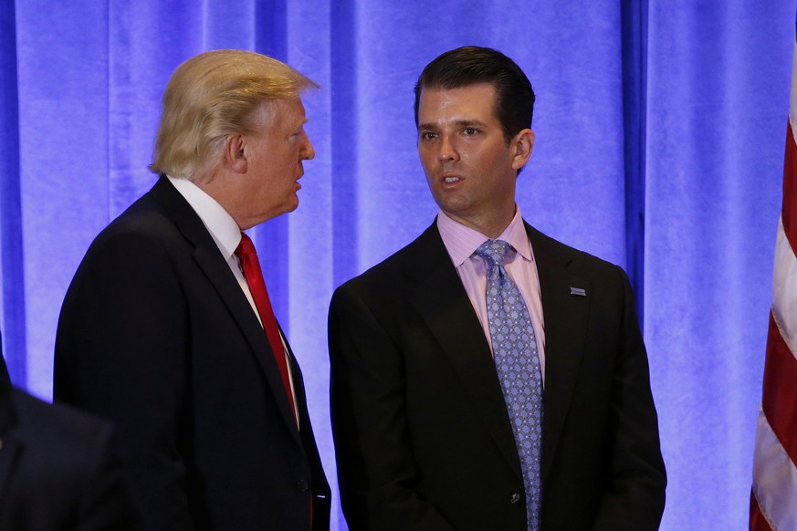 U.S. President-elect Donald Trump speaks with his son Donald Trump Jr. during a news conference in the lobby of Trump Tower in Manhattan, New York City, U.S., January 11, 2017. REUTERS/Lucas Jackson