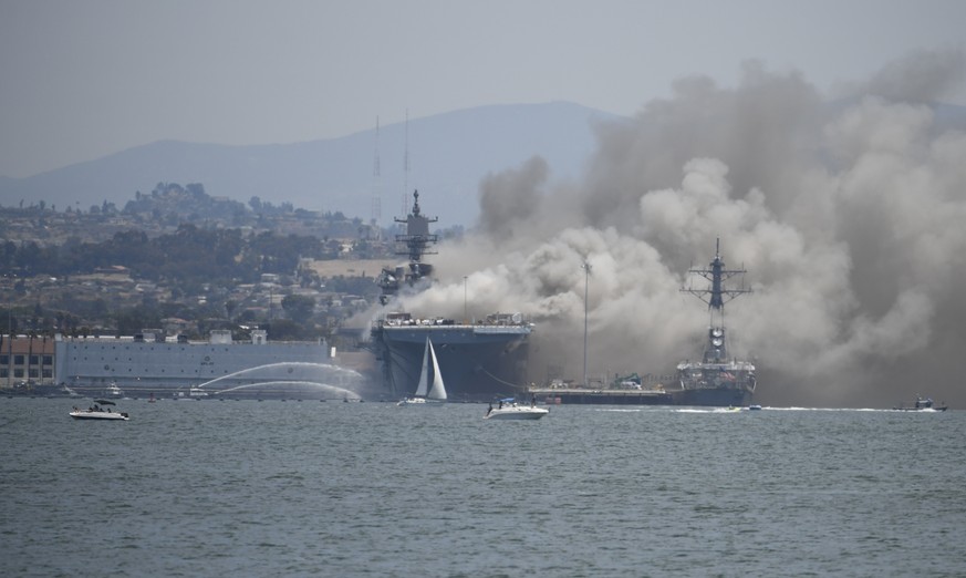 Smoke rises from the USS Bonhomme Richard at Naval Base San Diego Sunday, July 12, 2020, in San Diego after an explosion and fire Sunday on board the ship at Naval Base San Diego. (AP Photo/Denis Poro ...