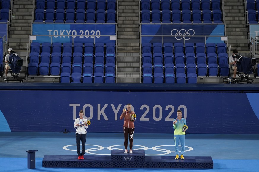 Gold medalist Belinda Bencic, middle, of Switzerland, silver medalist Marketa Vondrousova, left, of the Czech Republic, and bronze medalist Elina Svitolina, of the Ukraine, pose following the women&#0 ...