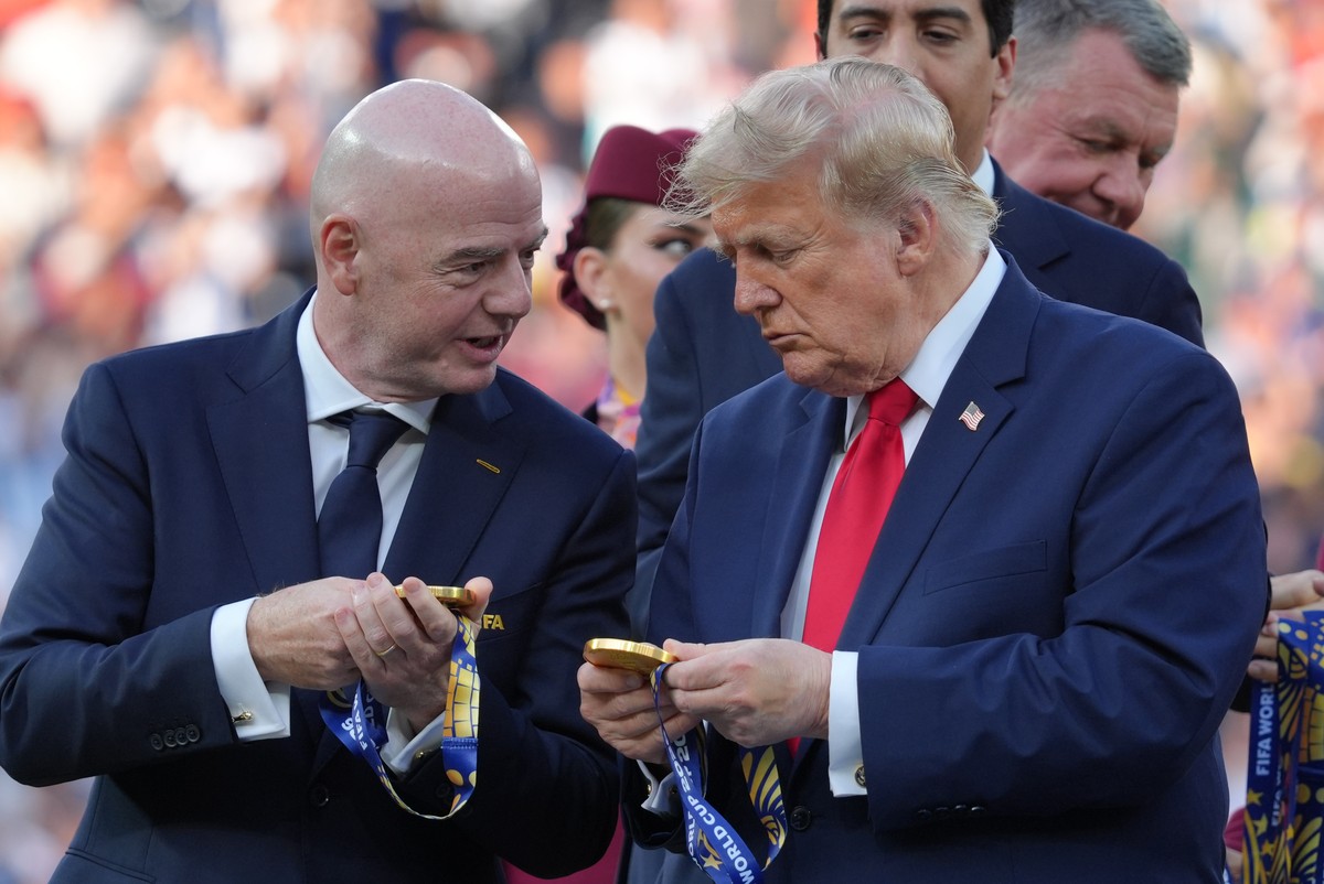 FIFA President Gianni Infantino, left, President Donald J. Trump comment on the medals as they wait to congratulate the Spanish players after the World Cup final soccer match between Spain and Argenti ...