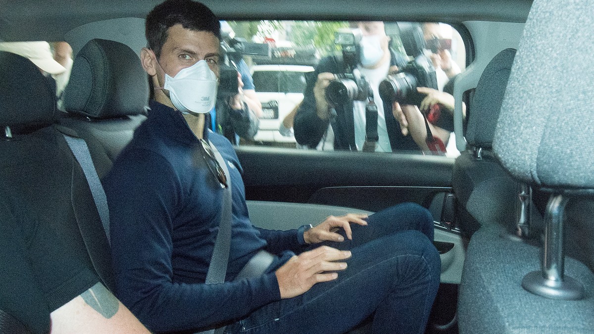 epa09688748 (FILE) - Serbian tennis player Novak Djokovic (C) departs from the Park Hotel government detention facility before attending a court hearing at his lawyers office in Melbourne, Australia,  ...