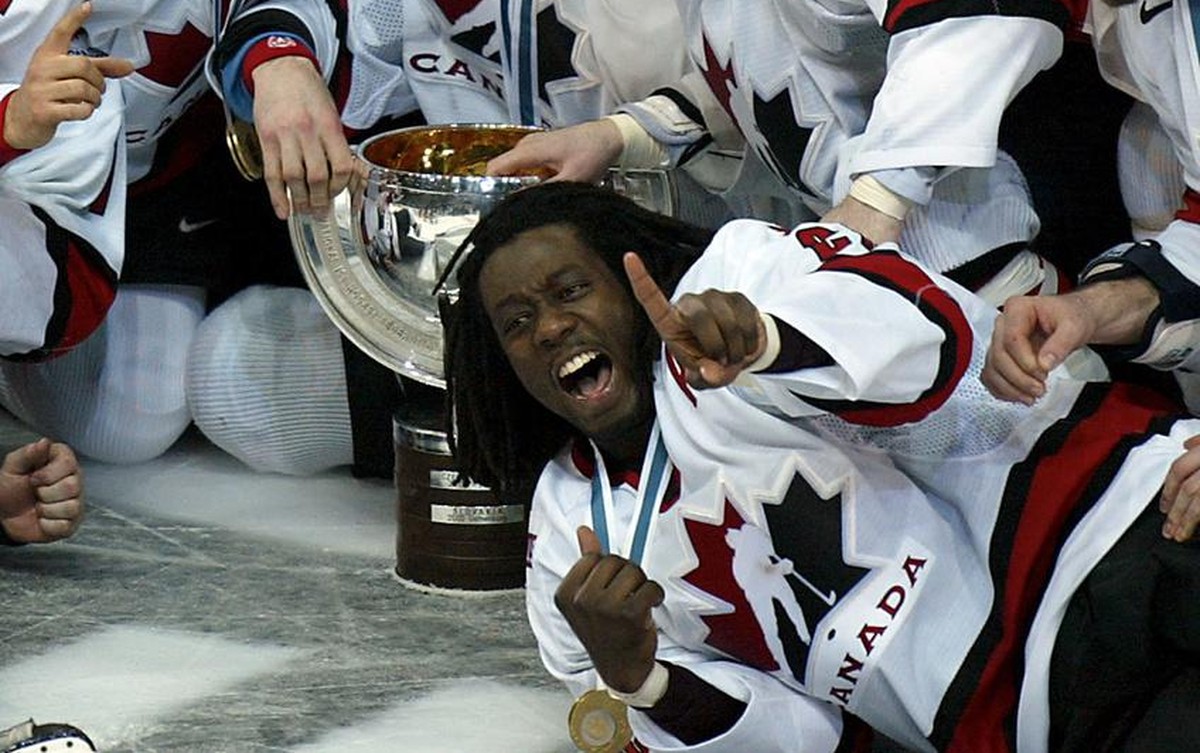 Canada's hockey players celebrate the winning of the gold medal at the Ice Hockey World Championship in Helsinki, Finland, Sunday, May 11, 2003. Canada defeated Sweden in the final 3-2 with an ov ...