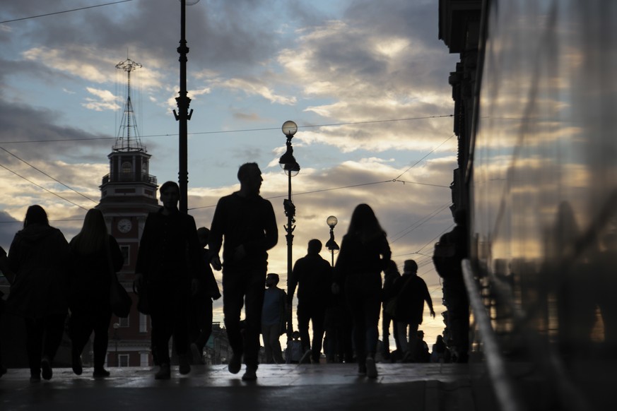 In this photo taken on Monday, July 24, 2017, people walk along Nevsky prospect, the central avenue in St.Petersburg, Russia. The U.S. has orchestrated the arrest of five alleged Russian cybercriminal ...