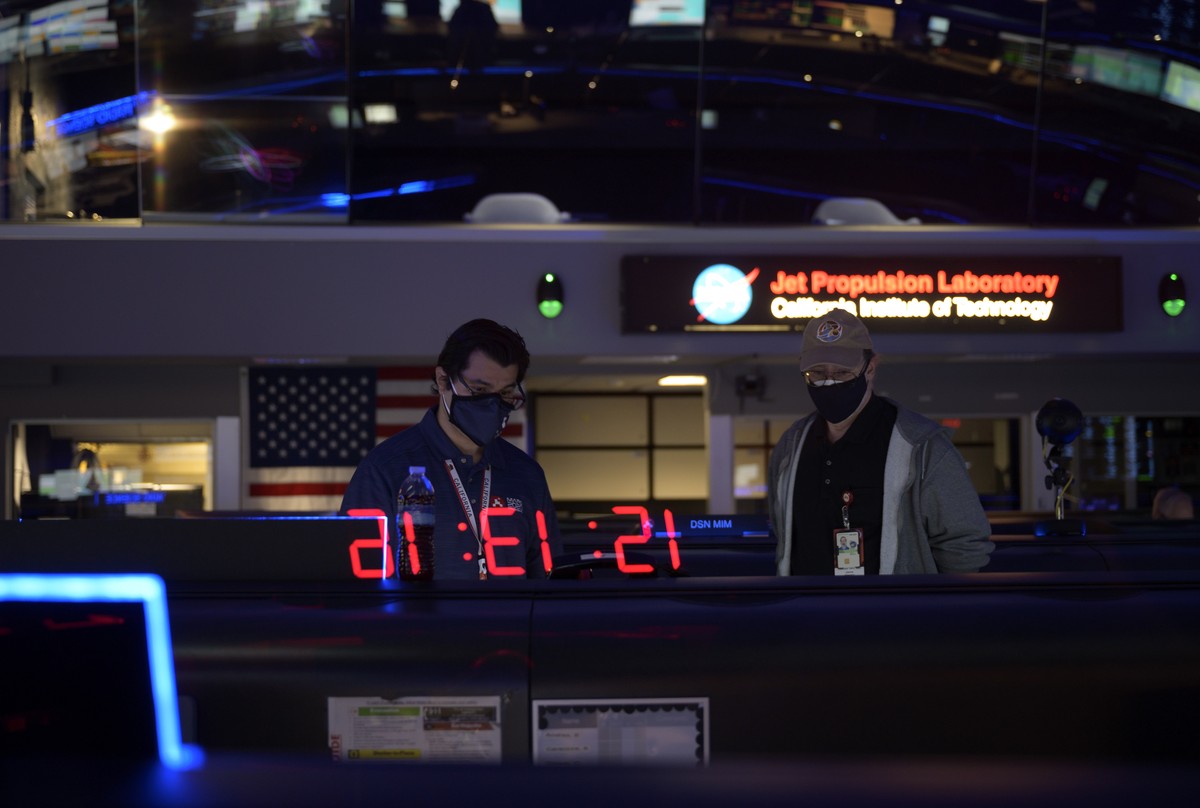 In this photo provided by NASA, members of the Perseverance Mars rover team study data on monitors in mission control, Thursday, Feb. 18, 2021, at NASA's Jet Propulsion Laboratory in Pasadena, Ca ...