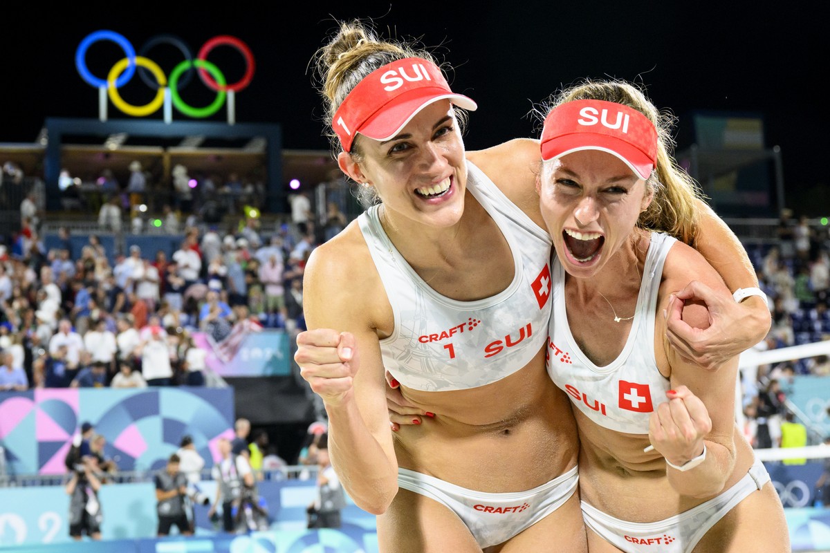 Nina Brunner, right, and Tanja Hueberli, left, of Switzerland celebrate the victory of the games against Kelly Cheng and Sara Hughes of United States during the women's beach volleyball quarterfi ...