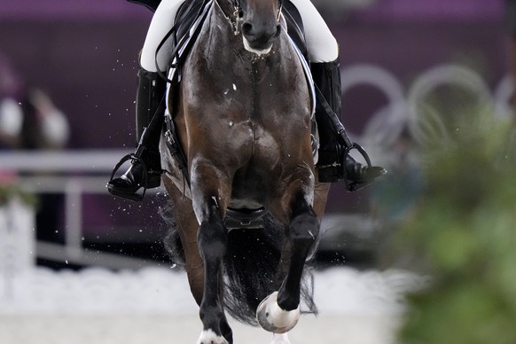 Sand is kicked up as Sweden&#039;s Juliette Ramel, riding Buriel K.H., competes in the equestrian dressage individual final at the 2020 Summer Olympics, Wednesday, July 28, 2021, in Tokyo. (AP Photo/D ...