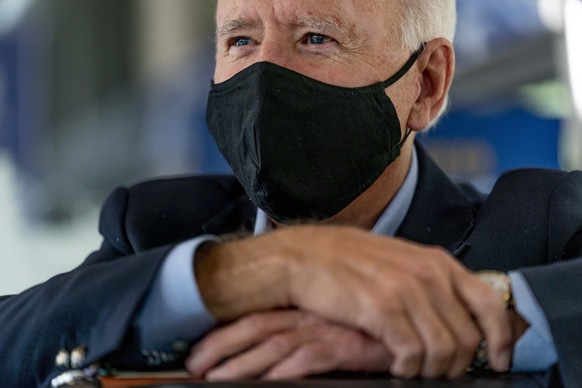 Democratic presidential candidate former Vice President Joe Biden speaks with United Steelworkers Union President Thomas Conway and school teacher Denny Flora of New Castle, Pa., aboard his train as i ...