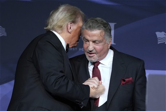 President-elect Donald Trump greets actor Sylvester Stallone during an America First Policy Institute gala at his Mar-a-Lago estate, Thursday, Nov. 14, 2024, in Palm Beach, Fla. (AP Photo/Alex Brandon ...