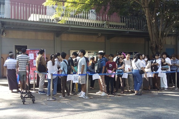 People wait in line to enter into the Thai Embassy for visa appointments in Yangon, Myanmar, Tuesday, Feb. 20, 2024. Crowds of people have thronged to get passports and visas to neighboring Thailand i ...