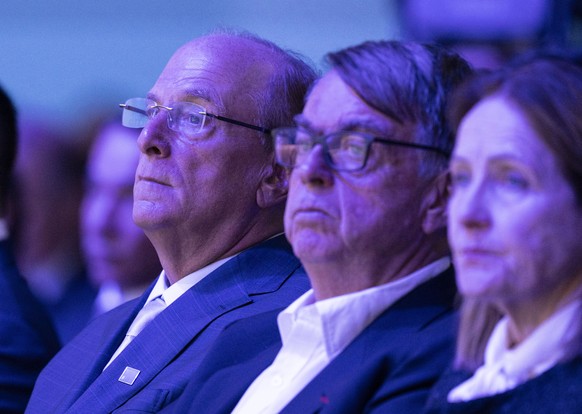 From L: Laurence Fink, Co-Chair of the WEF, is sitting next to Andre Hoffmann, Interim Co-Chair of the WEF and and Hoffmann's wife in the congess Hall at the 56th annual meeting of the World Econ ...