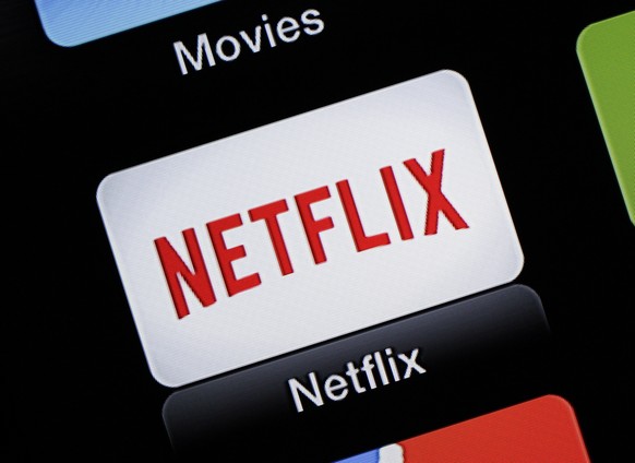 FILE - This June 24, 2015, file photo, shows the Netflix Apple TV app icon in South Orange, N.J. Netflix is raising prices for its video streaming customers in the U.S. and Canada, less than a year an ...