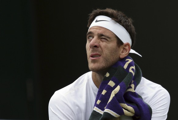 Argentina&#039;s Juan Martin Del Potro wipes his face during his Men&#039;s Singles Match against Australia&#039;s Thanasi Kokkinakis, on day two at the Wimbledon Tennis Championships in London Tuesda ...