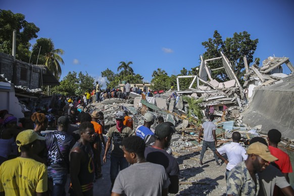 People search for survivors in a home destroyed by the earthquake in Les Cayes, Haiti, Saturday, Aug. 14, 2021. A 7.2 magnitude earthquake struck Haiti on Saturday, with the epicenter about 125 kilome ...