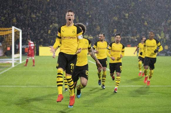 Dortmund&#039;s Marco Reus, left, celebrates after scoring his side&#039;s opening goal, during the German Bundesliga soccer match between Borussia Dortmund and VfB Stuttgart at the BVB stadium in Dor ...