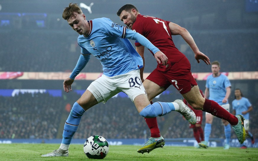 epa10376695 Cole Palmer of Manchester City (L) in action against James Milner of Liverpool (R) during the Carabao Cup Round of 16 soccer match between Manchester City and Liverpool FC in Manchester, B ...