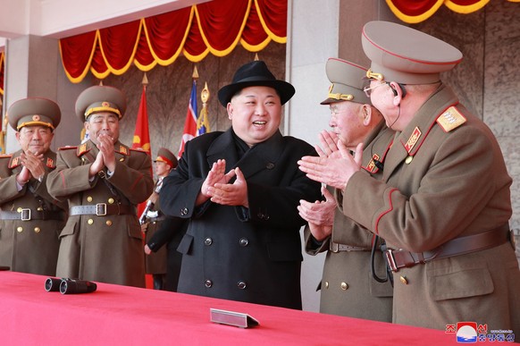 In this Thursday, Feb. 8, 2018, photo provided by the North Korean government, North Korean leader Kim Jong Un, center, attends a military parade to mark the 70th anniversary of the founding of its mi ...