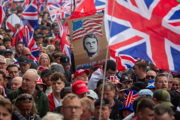 KEYPIX - epa12373348 Protesters display a placard among Union Flags during a &#039;Unite the Kingdom&#039; rally in central London, Britain, 13 September 2025. Two opposing demonstrations, involving t ...