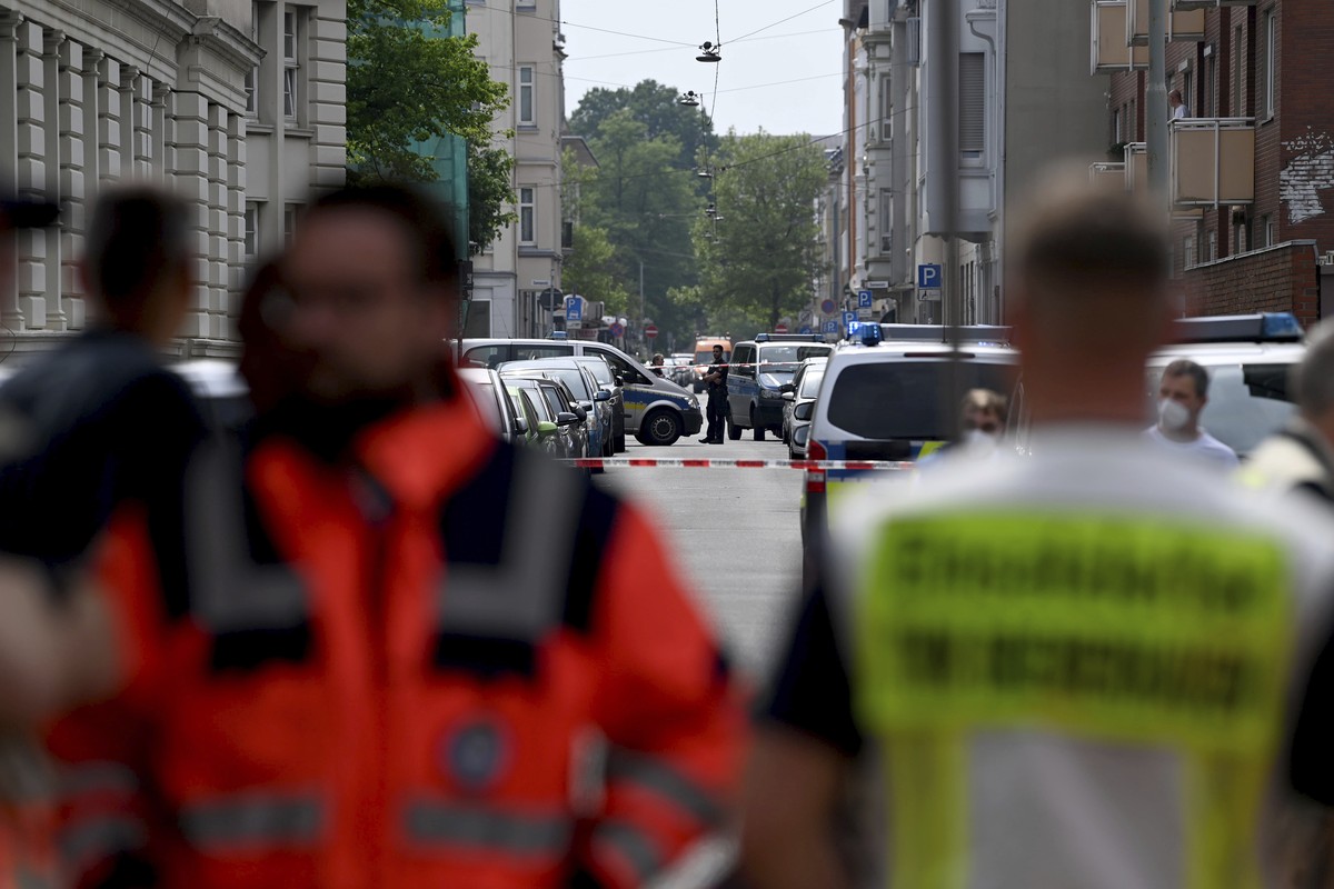 Police and emergency forces stand near a school in Bremerhaven, Germany, Thursday, May 19, 2022. German police say they have detained a suspect in connection with an attack at a high school in the nor ...