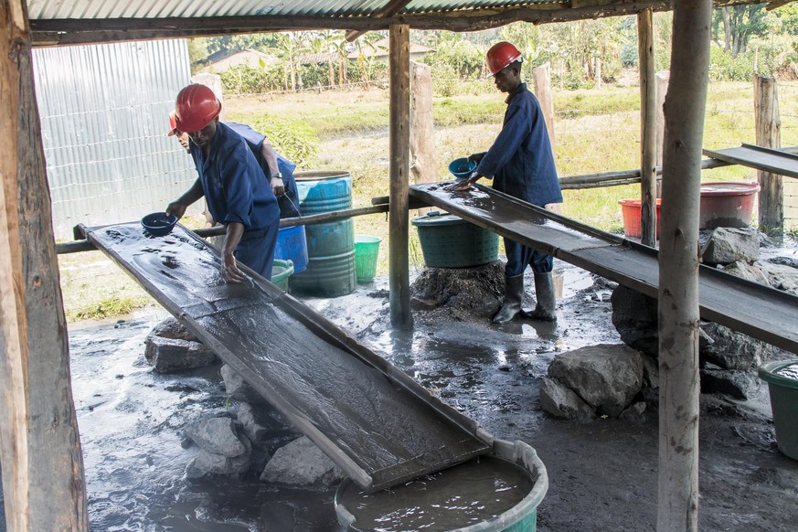 Arbeiter mit Schutzausrüstung in Ruanda waschen Wolfram, das in konfliktfreien Minen abgebaut wird. Im Fairphone wird das Metall genutzt, um den Vibrationsalarm bei eingehenden Anrufen und Nachrichten ...