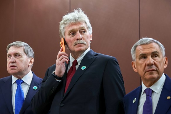 From left, Russian Presidential foreign policy adviser Yuri Ushakov, Kremlin spokesman Dmitry Peskov, and the Head of the Republic of Tatarstan Rustam Minnikhanov prior to the talks on the sidelines o ...