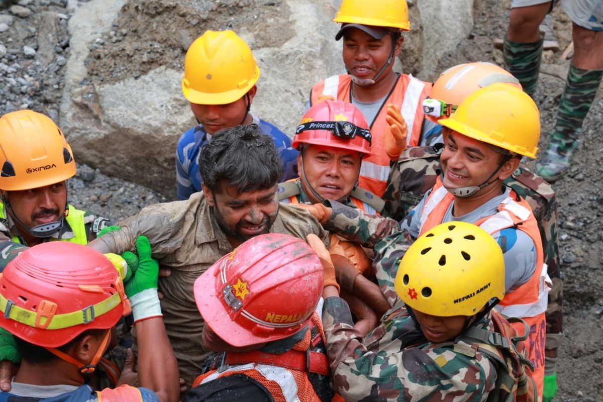epa13210504 A handout photo made available by the Nepali Army shows a worker rescued from a hydropower tunnel following flash floods in Rasuwa district, Nepal, 04 September 2026. Two people were rescu ...