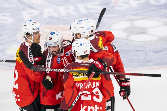 Switzerland&#039;s forward Denis Hollenstein, 2nd left, celebrates with team mates after scoring a goal during the ice hockey tournament NaturEnergie Challenge game between Switzerland and Slovakia at ...