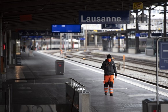 A person is walking on the platform of the Lausanne SBB CFF train station during the Covid-19 Coronavirus pandemic in Lausanne, Switzerland, Monday, March 23, 2020. The Swiss authorities proclaimed on ...