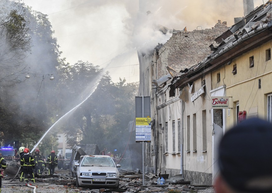 epa11583442 Ukrainian rescuers work at the site of a combined Russian strike that hit a residential area in Lviv, western Ukraine, 04 September 2024, amid the ongoing Russian invasion. At least seven  ...