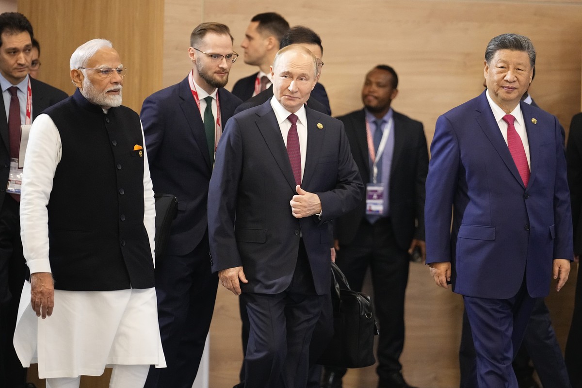 From left, Indian Prime Minister Narendra Modi, Russian President Vladimir Putin and Chinese President Xi Jinping attend a family photo ceremony prior to the BRICS Summit plenary session in Kazan, Rus ...