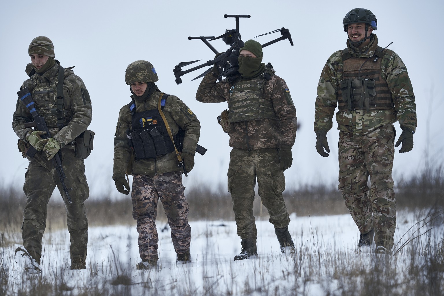 Ukrainian soldiers carry a drone close to the frontline near Avdiivka, Donetsk region, Ukraine, Friday, Feb. 17, 2023. (AP Photo/Libkos)