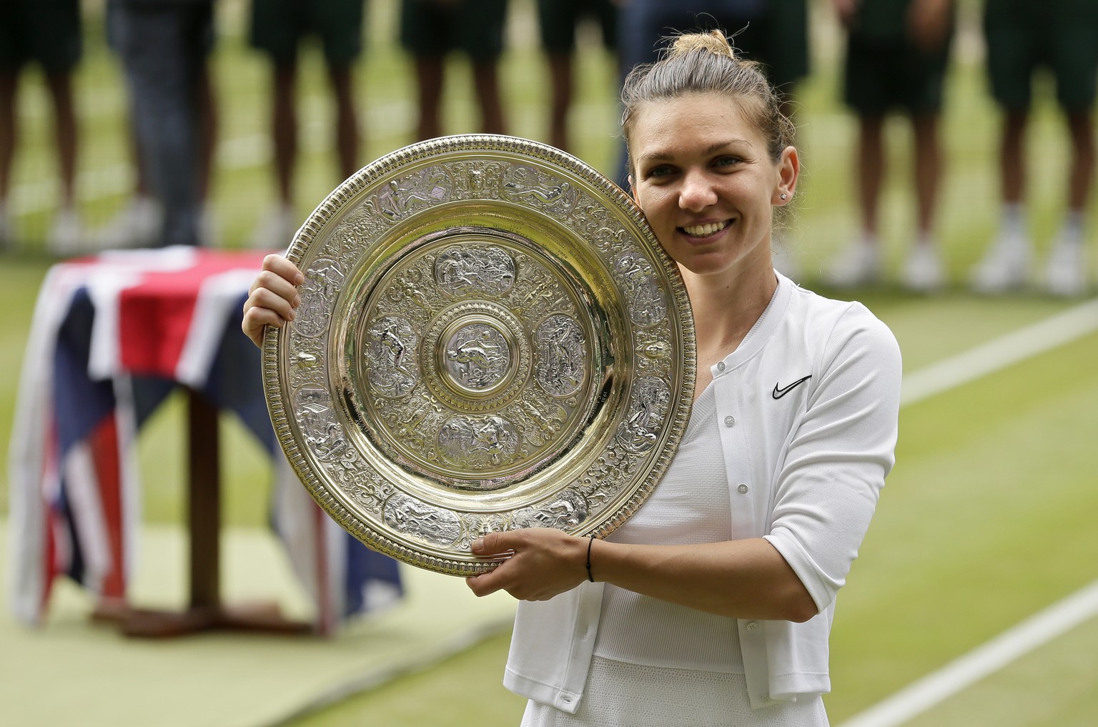 Romania&#039;s Simona Halep poses with her trophy after defeating United States&#039; Serena Williams in the women&#039;s singles final match on day twelve of the Wimbledon Tennis Championships in Lon ...