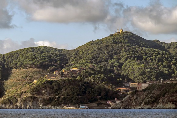 A glimpse of the Island of Gorgona, Livorno, Italy, seen from the sea xkwx hill, mountain, rock, green, ancient, architecture, bay, beach, beautiful, blue, boat, building, church, city, coast, europe, ...