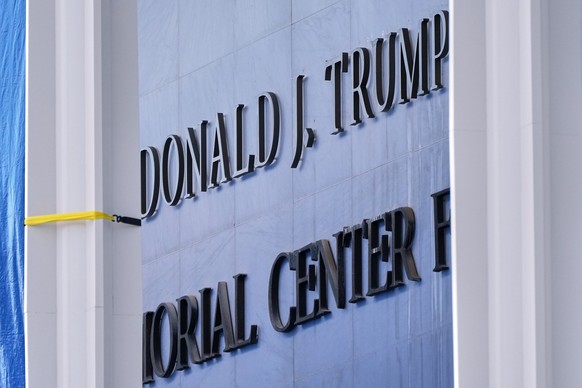 FILE - Workers install Donald J. Trump above the current signage on the John F. Kennedy Memorial Center for the Performing Arts on Dec. 19, 2025, in Washington. (AP Photo/Jacquelyn Martin)
America 250 ...