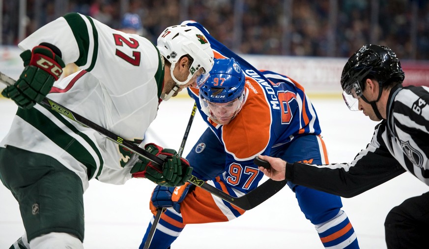 Edmonton Oilers&#039; Connor Mcdavid (C) faces off against Minnesota Wild&#039;s Brett Sutter during the third period of their NHL hockey game in Saskatoon, Saskatchewan September 26, 2015. The Edmont ...