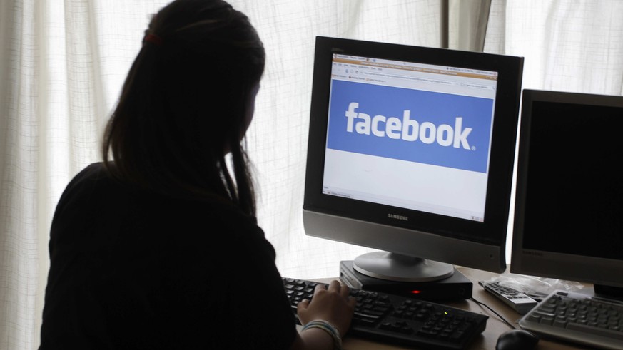 FILE - In this Monday, June 4, 2012, file photo, a girl looks at Facebook on her computer in Palo Alto, Calif. &quot;Fake news,&quot; which has gotten a lot of attention for its potential role in sway ...