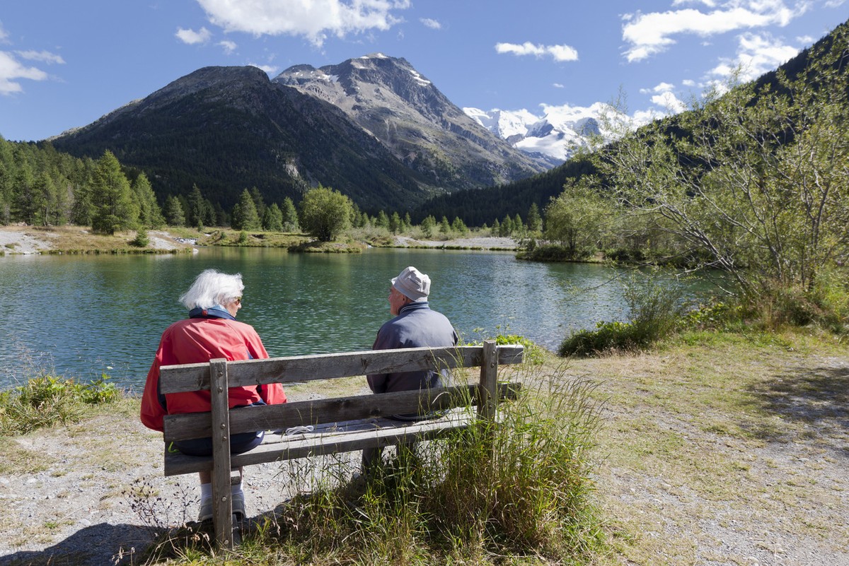 An elderly couple sitting on a bench at a lake near "Morteratsch" above the village of Pontresina in the canton of Grisons' Upper Engadine Valley, Switzerland, pictured on August 16, 20 ...