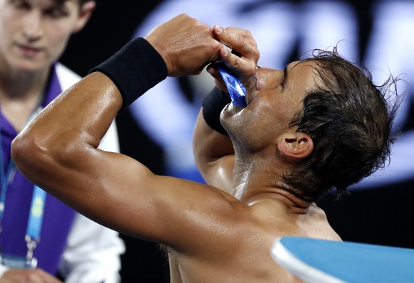 Spain's Rafael Nadal takes a snack during a break in his semifinal against Bulgaria's Grigor Dimitrov at the Australian Open tennis championships in Melbourne, Australia, Friday, Jan. 27, 2017. (AP Photo/Kin Cheung)