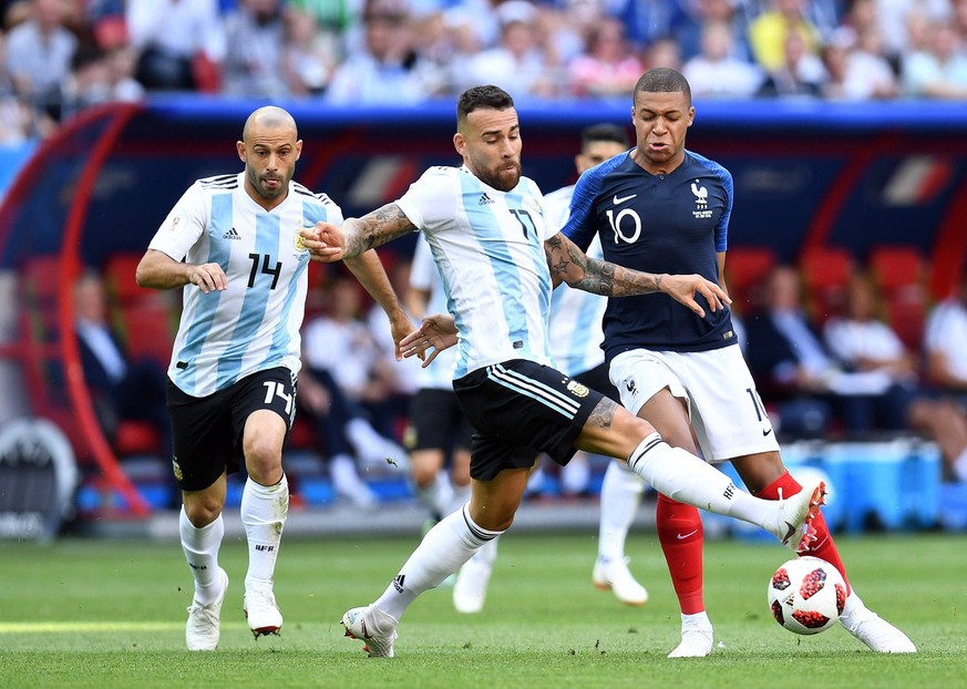 Soccer: World Cup-France vs Argentina, Jun 30, 2018 Kazan, Russia France forward Kylian Mbappe 10 chases the ball with Argentina defender Javier Mascherano 14 and defender Nicolas Otamendi 17 in the r ...