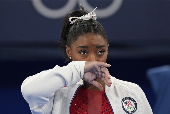 Simone Biles, of the United States, watches gymnasts perform after an apparent injury, at the 2020 Summer Olympics, Tuesday, July 27, 2021, in Tokyo. Biles withdrew from the team finals. (AP Photo/Ash ...