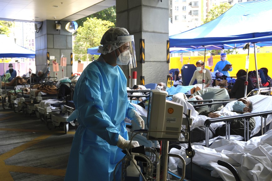 FILE - Patients in hospital beds wait in a temporary holding area outside Caritas Medical Centre in Hong Kong on March 2, 2022. Some people are forced to wait outside the hospital due to it currently  ...