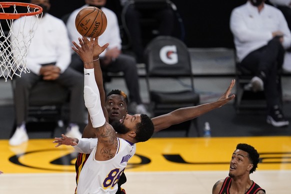 Los Angeles Lakers forward Markieff Morris, bottom left, drives to the basket as Atlanta Hawks center Clint Capela defends during the first half of an NBA basketball game Saturday, March 20, 2021, in  ...