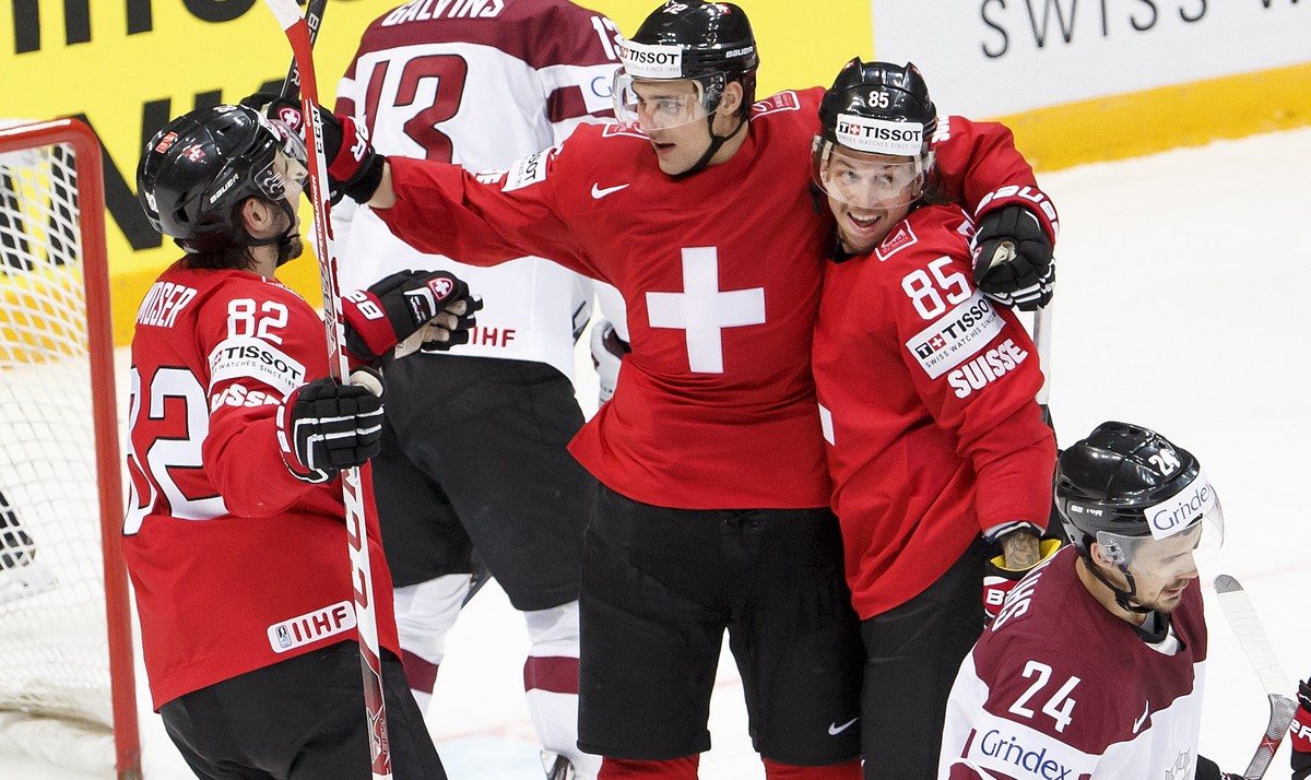 Switzerland's Nino Niederreiter, centre, celebrates his goal with teammates Simon Moser, left, and Sven Andrighetto, right, after scored the 2:0, during the IIHF 2016 World Championship prelimina ...
