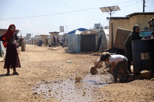This Sunday, April 19, 2020, photo, shows a large refugee camp on the Syrian side of the border with Turkey, near the town of Atma, in Idlib province, Syria. The rapid spread of the coronavirus has ra ...
