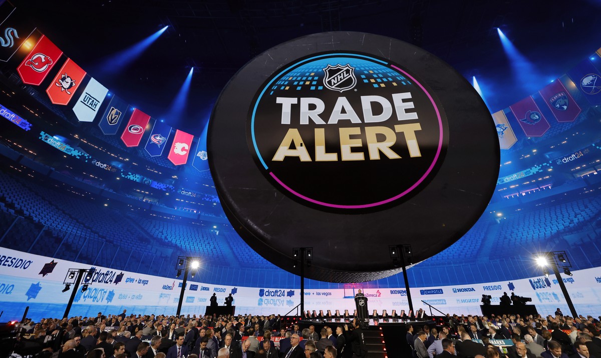A trade alert message is displayed on the video screen during the first round of the NHL hockey draft Friday, June 28, 2024, in Las Vegas. (AP Photo/Steve Marcus)