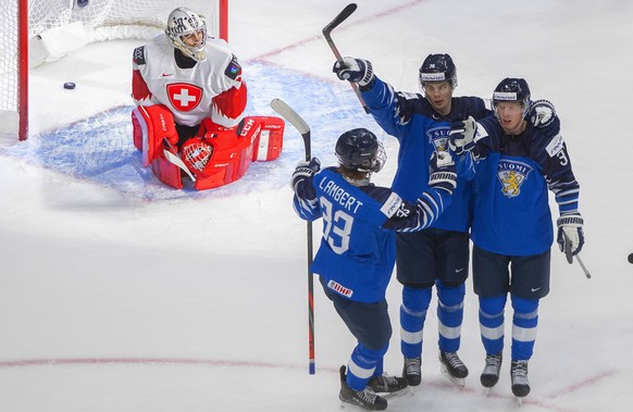 Finland&#039;s Brad Lambert (33), Henri Nikkanen (28) and Aku Raty (34) celebrate a goal as Switzerland goalie Thibault Fatton (29) looks on during third-period IIHF World Junior Hockey Championship a ...