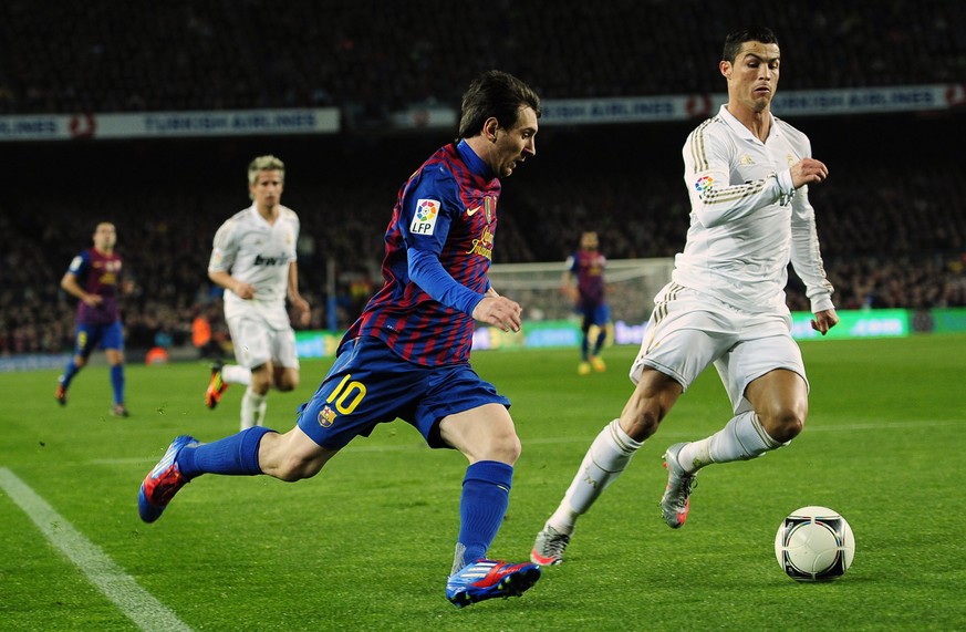 FILE - FC Barcelona&#039;s Lionel Messi from Argentina, left, duels for the ball against Real Madrid&#039;s Cristiano Ronaldo, from Portugal, during their quarterfinal, second leg, Copa del Rey soccer ...