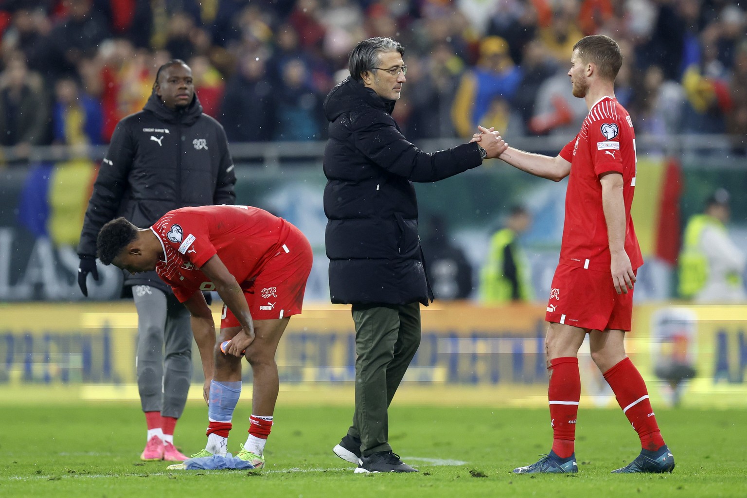 Switzerland&#039;s disappointed Nico Elvedi, head coach Murat Yakin, Dan Ndoye and Denis Zakaria, from right, after the UEFA Euro 2024 qualifying group I soccer match between Romania and Switzerland a ...