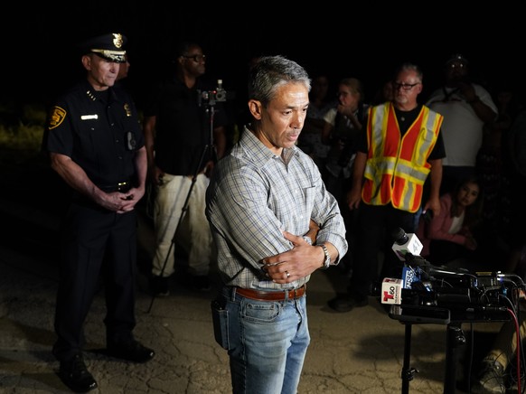 San Antonio Mayor Ron Nirenberg, center, with San Antonio Police Chief William McManus, left, brief media and others at the scene where they said dozens of people have been found dead and multiple oth ...