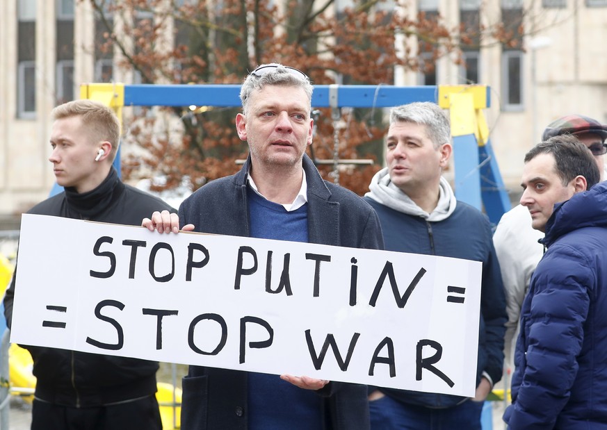 epa11226081 A man protests against Russian presidential elections, as Russian in Latvia wait in line on last day of voting in the Russian presidential election at the Russian embassy in Riga, Latvia,  ...