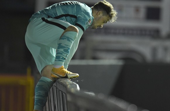 Liverpool&#039;s Xherdan Shaqiri climbs over the hoarding to get the ball during the English League Cup third round soccer match between Lincoln City and Liverpool at the LNER stadium, Lincoln, Englan ...